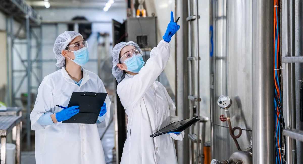 Two inspectors auditing a food processing facility