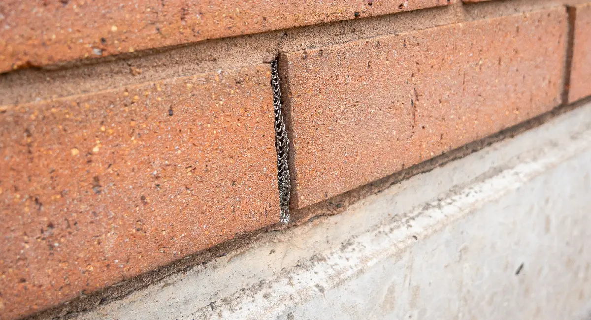 A gap in brickwork sealed with Flexi Armour Weep rodent-proofing
